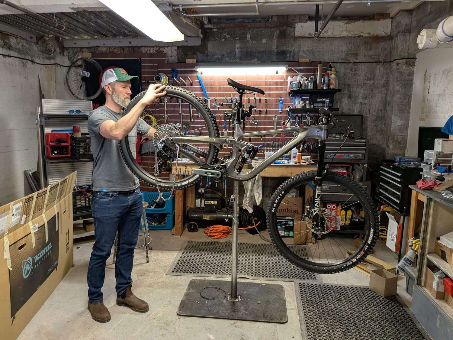 A bike up on a repair stand in a home workshop