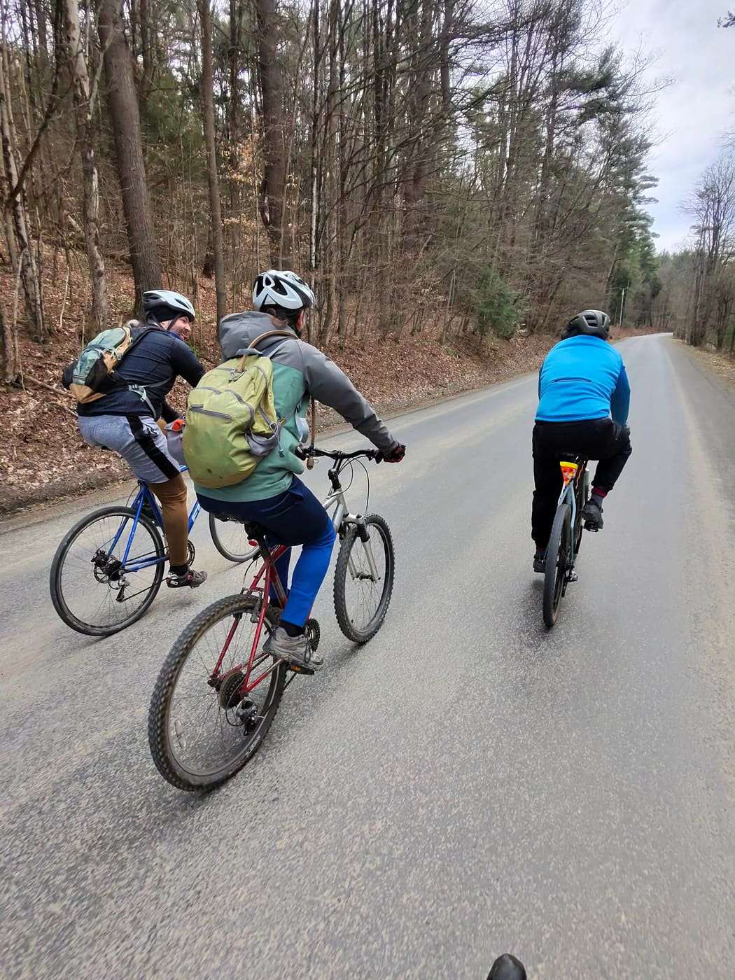 Three riders on a quiet road in early spring